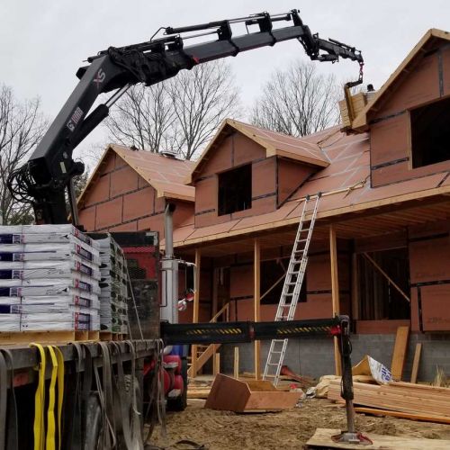 Crane to get roofing tiles onto the roof